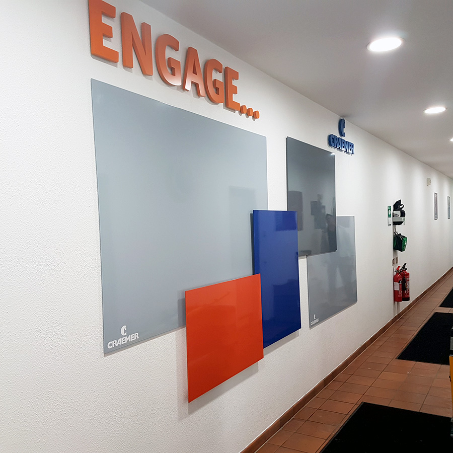 overlapped coloured printed whiteboards on a wall