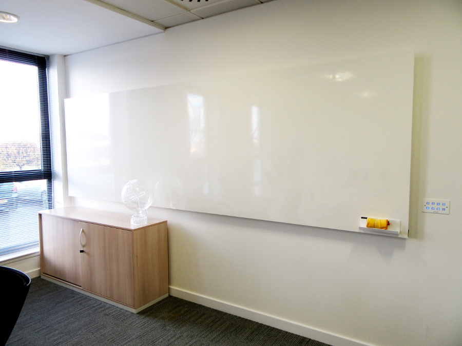 Bespoke wall mounted frameless magnetic whiteboard in an office
