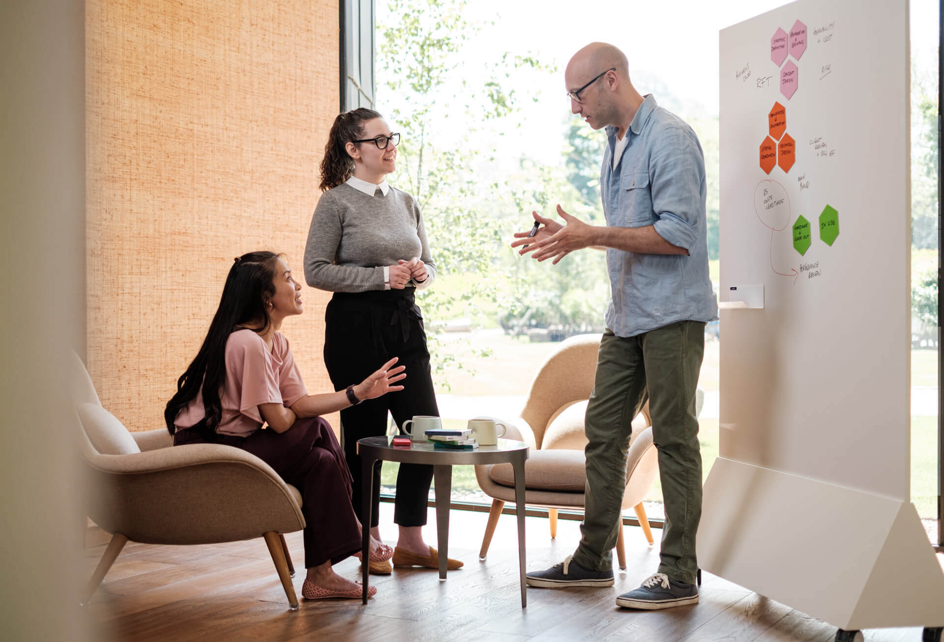 Casual meeting area with low seating and mobile whiteboard