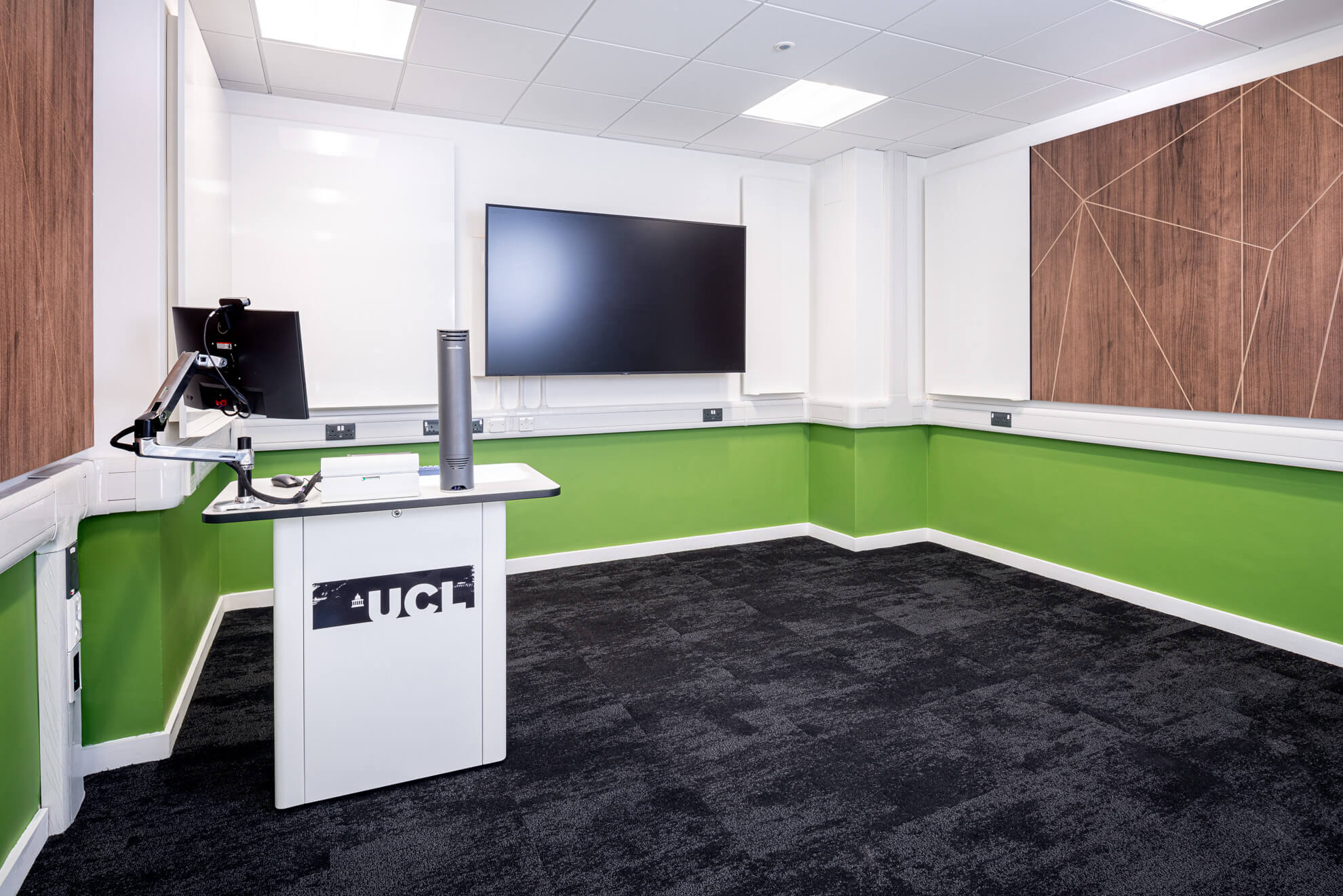 Textured acoustic wall with whiteboard and digital screen in a teaching room at University College London