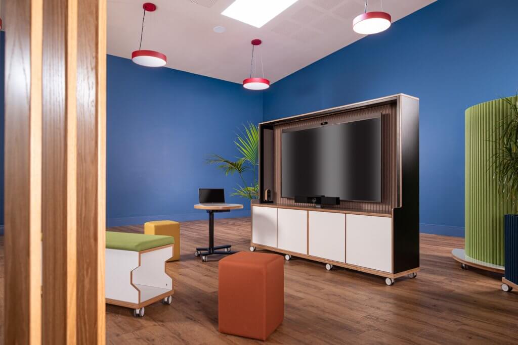 Mobile media wall in office setting with bench and table